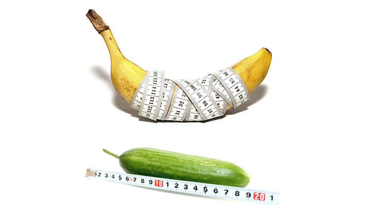 Abstract photo of banana in form of large male penis with good potency and cucumber in form of large male penis with bad potency isolated on white background
