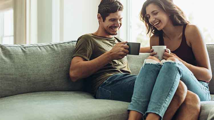 Couple relaxing at home with coffee