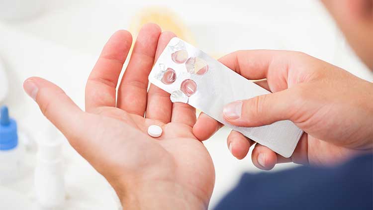 Man Taking Pill Out From Blister Pack