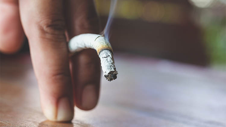 Man hand with burning cigarette as penis in smoking cause sexual erectile dysfunction, tobacco causes to Erectile dysfunction