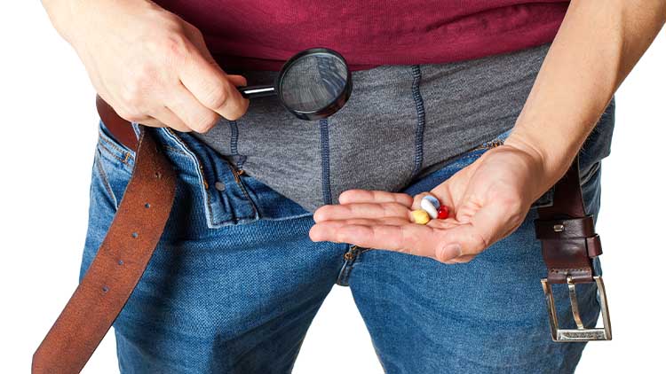 Man's crotch while holding potency pills
