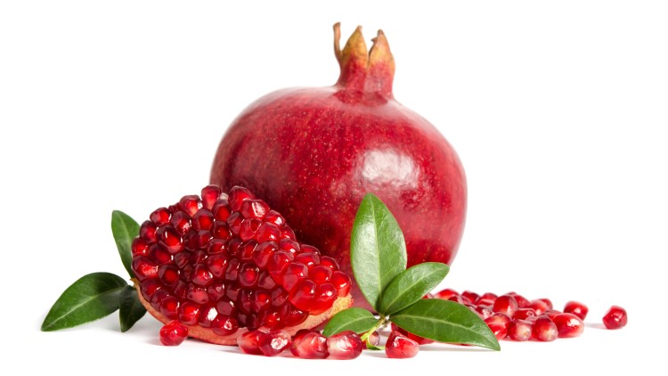 One whole pomegranate on white background
