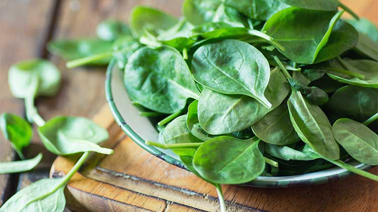 spinach leaves on a chopping board